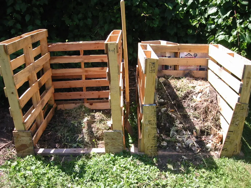 Two compost bins made from wooden pallets side by side
